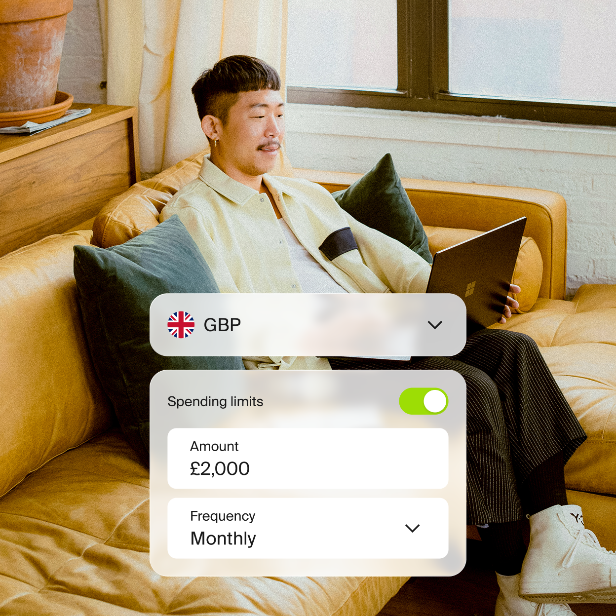 Person on couch with Incard spending limits widget overlay showing GBP, £2,000 monthly limit